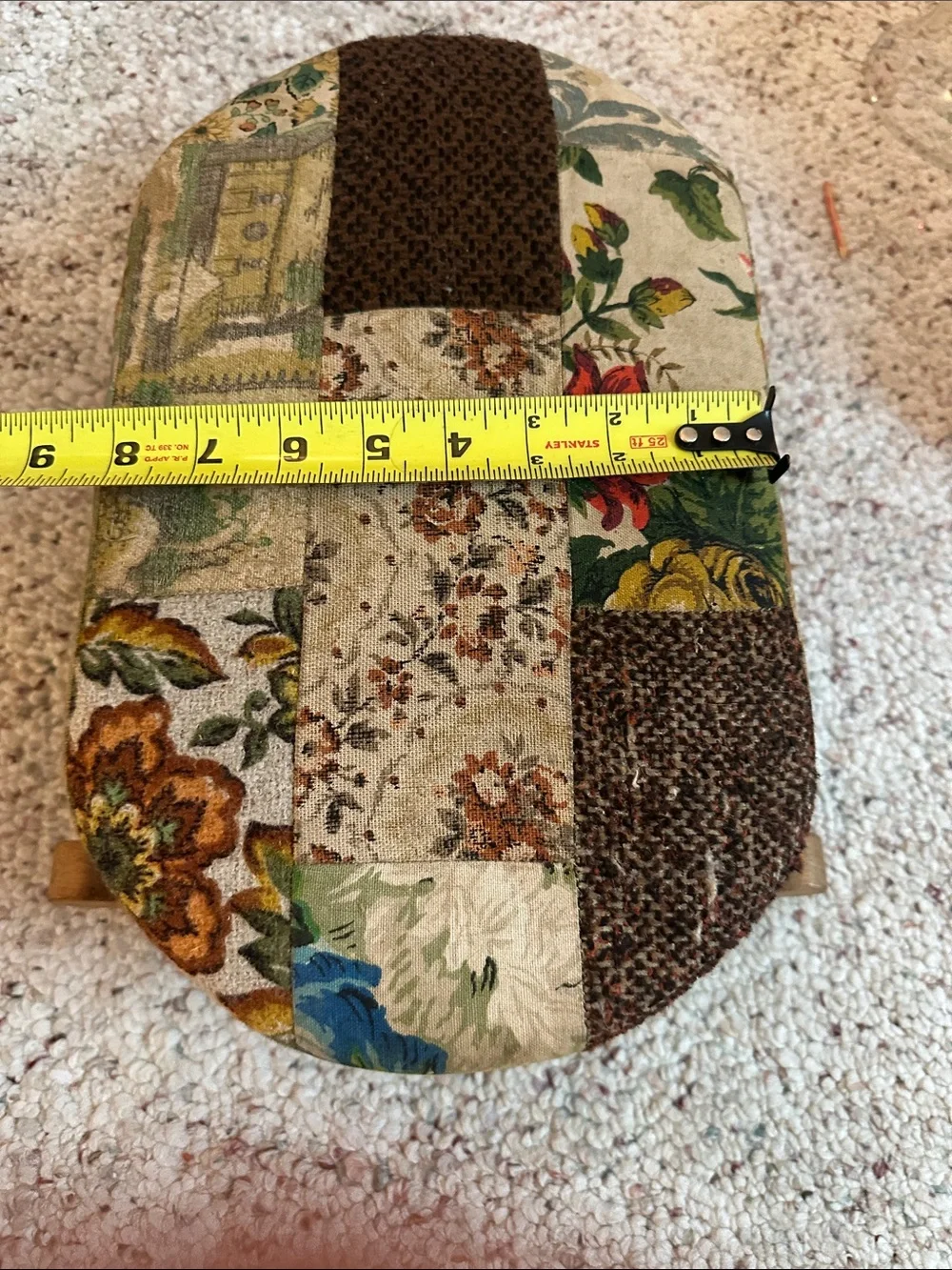Antique wooden rocking footstool features a charming multicolor floral tapestry